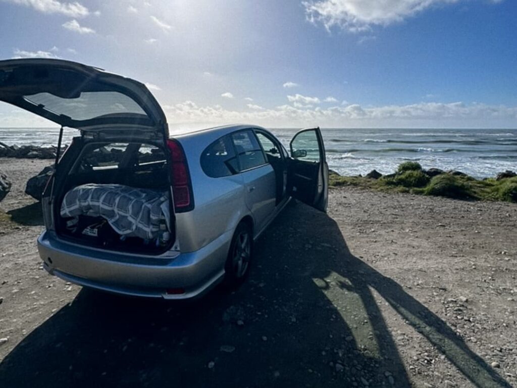 Van estacionada en un paisaje de montaña durante un viaje por la Isla Sur de Nueva Zelanda.